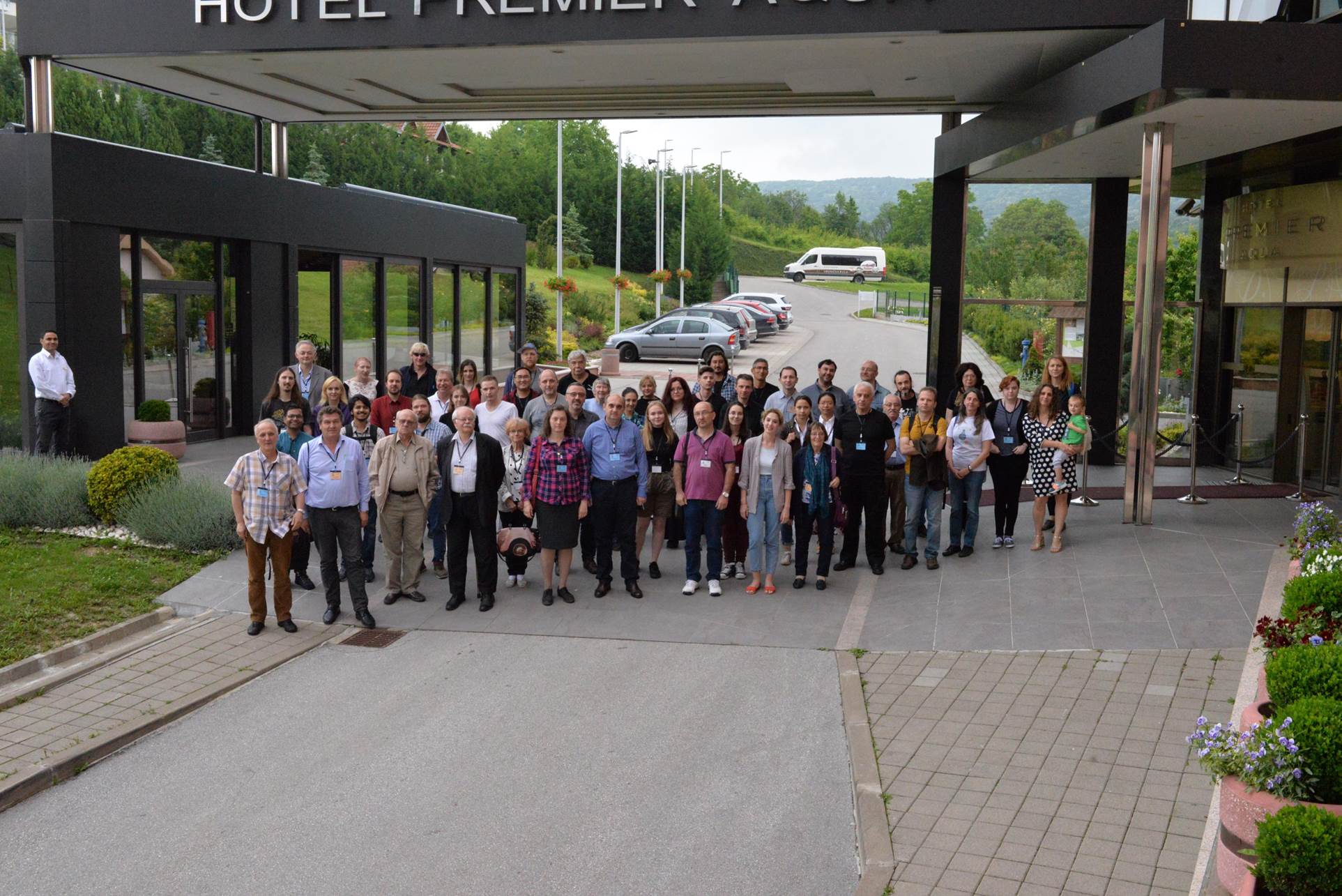 A group of people standing outside of a building

Description automatically generated